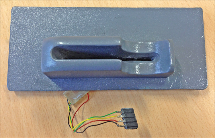A photograph of a fake ATM card slot is shown, which has a slot to insert the card and a connector attached to it through wires