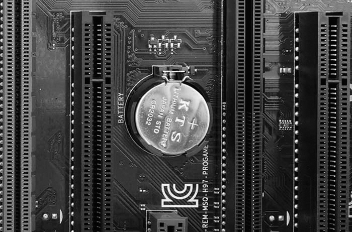 A photograph displays a CMOS battery on the motherboard. It is of KTS brand that is made up of Lithium.