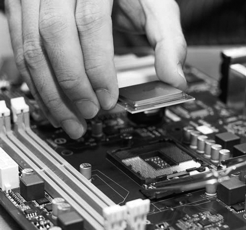 A photograph shows a person installing a processor on a motherboard.