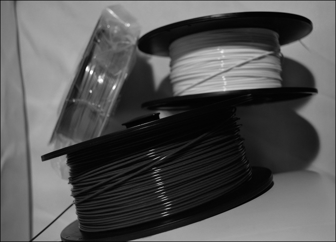 A photograph shows three rolls of the plastic filament.