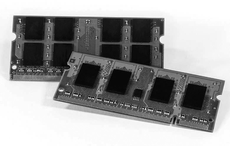 A photograph of two RAM chips with memory cells is shown.