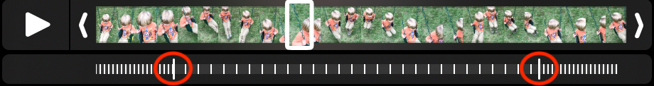 Figure 52: Adjust the handles (circled in red) to change the placement of the slow-motion effect in the video. The slow-motion portion is denoted by the widely spaced white lines.