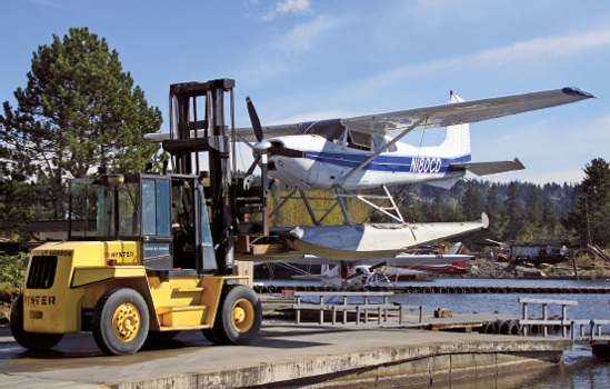 A wide-angle lens captures the action of this scene as a float plane is moved to the water for takeoff. This image was taken with a zoom lens set to 40mm, which is equivalent to 64mm on the EOS 30D. As a result of the focal length multiplication factor on the 30D, less of the scene is included than would be on a full-frame camera.