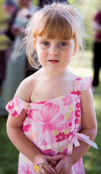 A cute little girl with a wilted dandelion that she had faithfully carried in her hand all afternoon creates a simple but poignant portrait.