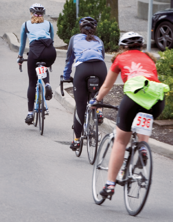 A holiday bicycle race provided colorful images of the event including this one of riders coming into a rest stop. Taken at ISO 100, f/11, at 1/60 sec. using the Canon EF 70–200mm f/2.8L IS USM lens set to 140mm.