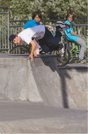 I like to get clean backgrounds for action shots, but in this scene, it wasn't possible. The boys watching the skater are distracting, but, on the other hand, they add the element of an audience. Exposure: ISO 200, f/5, 1/3200 second using an EF 70-200m f/2.8L IS USM lens.