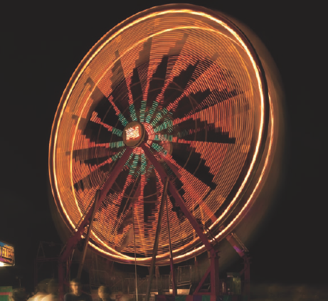 This image of a Ferris wheel in motion was shot with a monopod that I stabilized by wedging it between the back and seat sections of a bench, and then pushing the monopod forward with one hand to stabilize it. Exposure: ISO 400, f/18, 2.5 seconds using an EF 24-70mm f/2.8L USM lens.