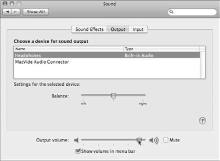 Adjusting the sound output volume on a Mac with headphones attached.