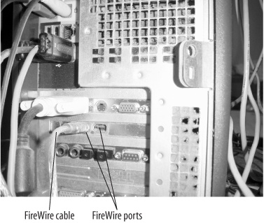 FireWire cable connected to the port on the back of a tower computer.