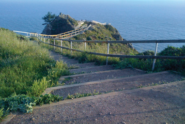 The winding stairs lead to a focal point at the end where the people are.