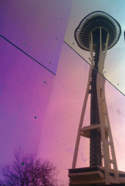 A reflection of Seattle’s Space Needle on sheet metal.