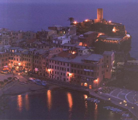 Vernazza, one of the small villages of Italy's Cinque Terra region, glows with lights as twilight deepens. Shooting in the RAW file format mode makes it easy for you to later decide whether you want the warm color balance of the village lights or the cool blues of twilight—or something in between, Exposure at 1 second, f/4.8.