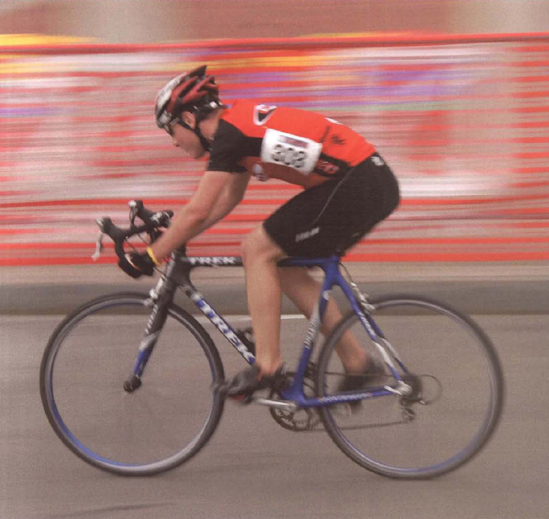 A shutter speed of 1/30 second conveyed die speed of this cyclist racing down a straightaway. Exposure at 1/30 second, f/16.