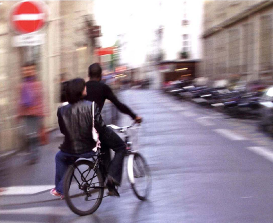 Mating a turn, bicyclist and friend seem to be leaving you behind as they bead down a Parisian street for an unknown destination. Exposure at 118 second, f/11.