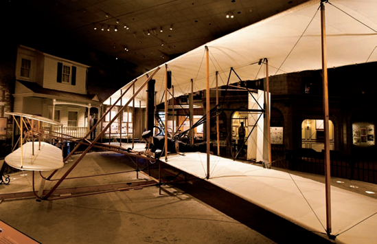 Orville and Wilbur Wright's 1903 Wright Flyer, taken at its temporary location inside The Wright Brothers and The Invention of the Aerial Age exhibit. Taken at ISO 3200, f/4, 1/30 second with a 20mm lens.