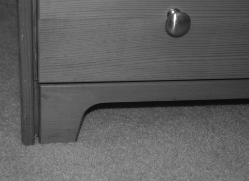 A straight view of the dresser's bottom corner