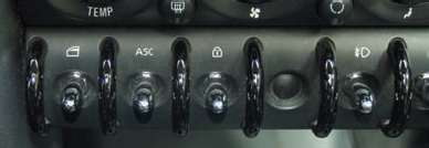 These switches in my MINI Cooper S look slick but don't show state very well because they return to the same position regardless of whether they are activated. There's a tiny LED at the end of the switch for traction control, but it's so invisible it might as well not be there.