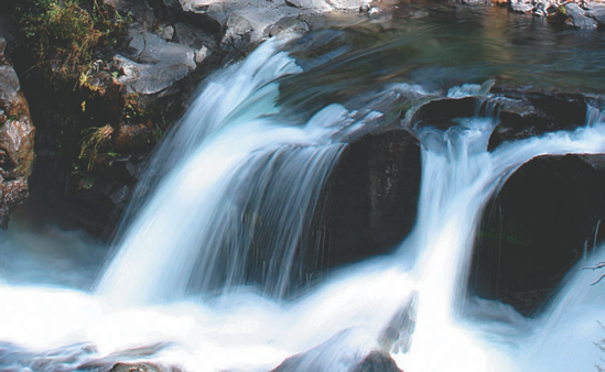 A long exposure blurs the foam of a waterfall.