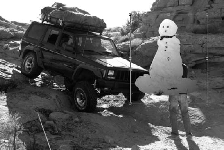 Use the Free Transform tool to correctly size and place the snowman in the Jeep image.