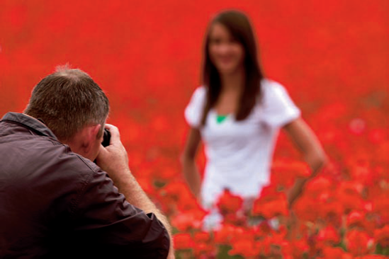 I captured photographer Ted Miller creating senior portraits of a young lady at a nearby poppy field. A large aperture was used for a 350mm lens to keep the focus only on him and blur the entire background. Exposure: ISO 50, f/5.6, 1/250 second.