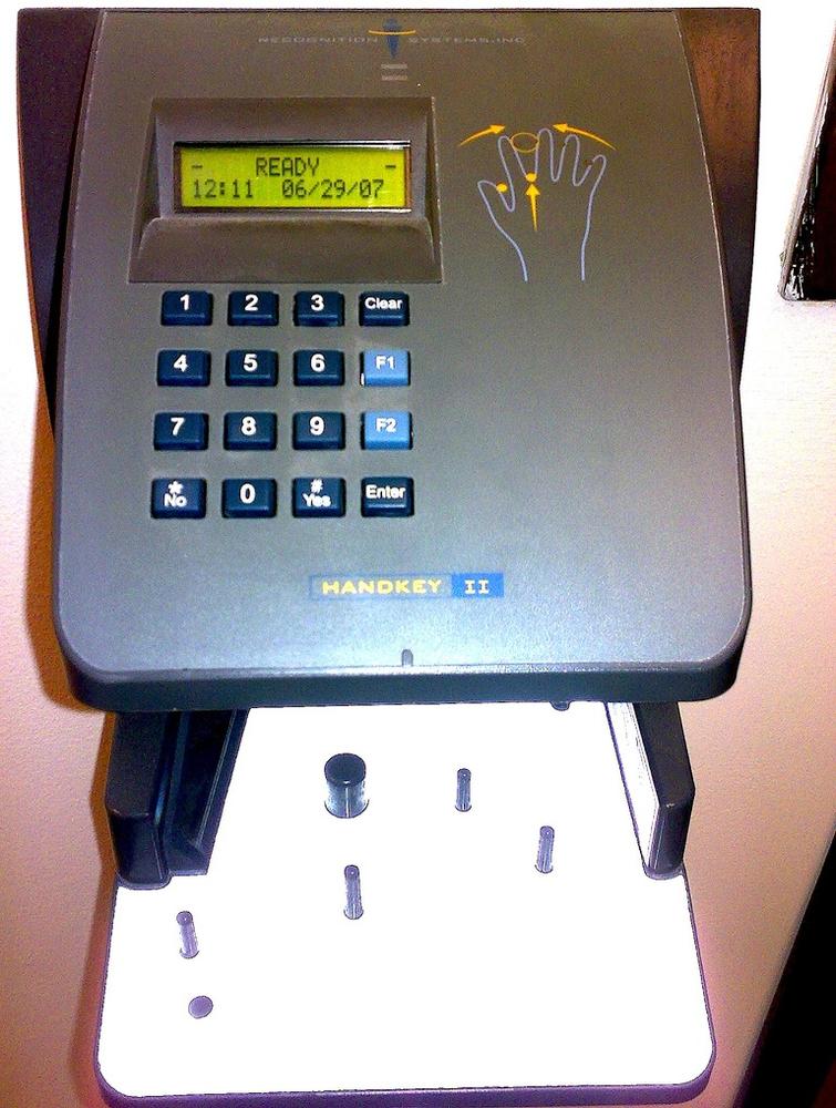 This hand scanner requires that a hand be placed in a certain position to be read, thus the illustration. It would have been better to put the illustration right where the hand needs to be placed. Courtesy John Manoogian III.