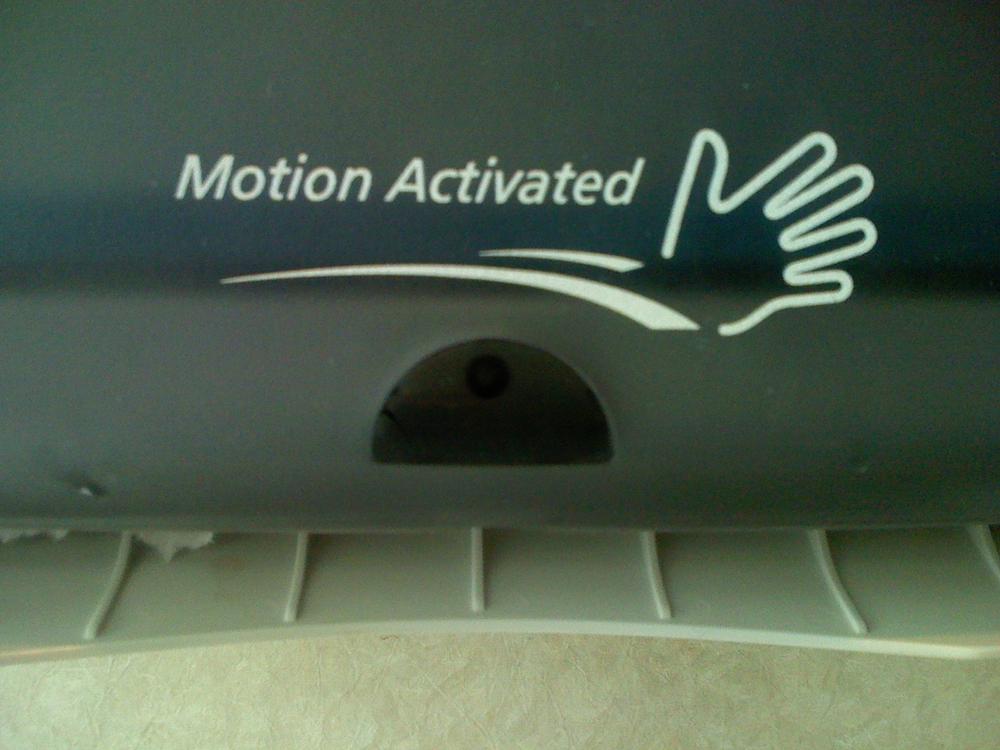 This paper towel dispenser combines a well-designed illustration showing the left-to-right movement required to trigger the device, with a small bit of text to show presence.