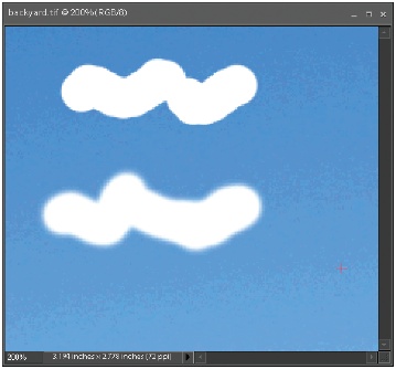 These two Selection brushstrokes show the way the Hardness setting affects the edges of your selection. Here, two different selections were made in the sky. The top selection was made at 100-percent hardness, and the bottom one is at 50 percent. (The selected area was then deleted to show you the outline more clearly.)