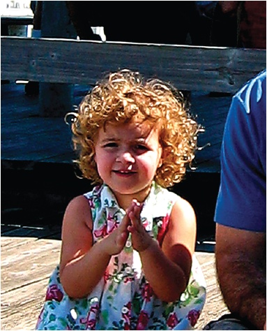 Although the overall shadow/highlight balance of this photo is about right, the detail in the face of this little concert-goer is obscured by backlighting and by her father’s shadow. Careful dodging and burning can really improve these problems, as you can see in .