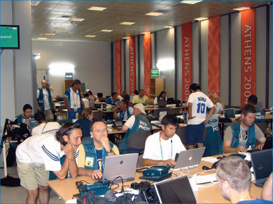 Olympic photographers working in the main media facility, where access is strictly limited to working, credentialed photographers