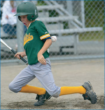 This photo by photographer Adam Hardtke captures the drama and action of Little League baseball. Shot at 1/2000 of a second, a digital SLR is essential in catching stop-action images: © Adam Hardtke.