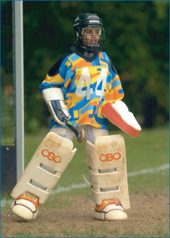 A field hockey goalie in full gear — an interesting and important photo for documenting and visually describing an event: © Joy Absalon