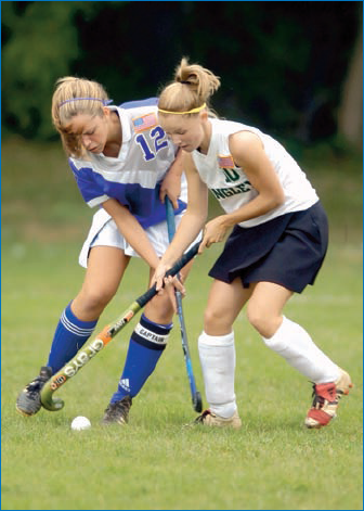 As with lacrosse, field hockey is best shot with a telephoto lens; some of the most exciting shots are of opponents battling for control of the ball.: © Joy Absalon