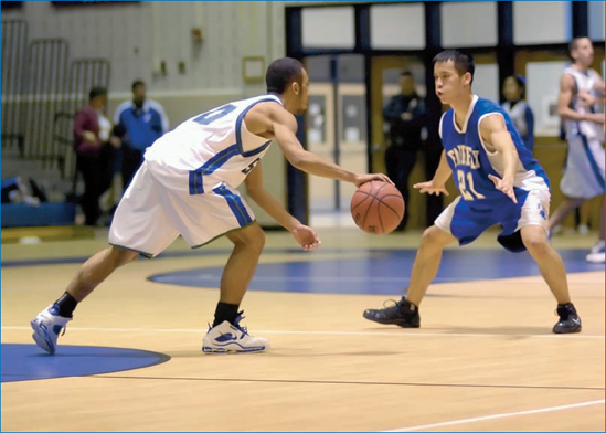 Whether in a tight run or a face-off, getting a basketball player dribbling a ball while facing an obstacle or challenge always makes for good visual drama.: © Joy Absalon