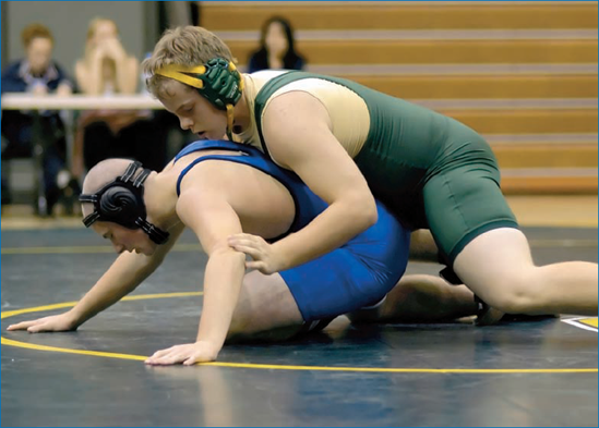 A very narrow depth-of-field wrestling image (shot at f/1.8) taken at the eye level of the competitors. The image was taken at ISO1600 to be able to stop the action.: © Joy Absalon