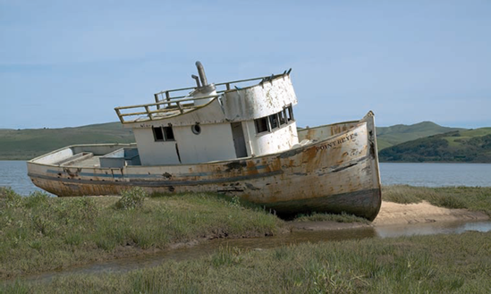 This otherwise mundane landscape is made interesting by the grounded tugboat.