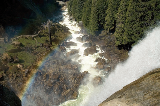 The rainbow created by the spray from the waterfall helps to add another dimension to this image.