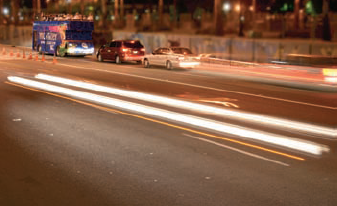 Choose shutter priority and use a longer exposure to capture traffic at night.