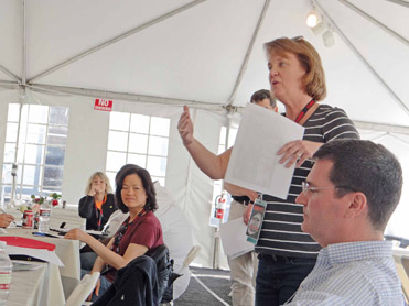 Figure 2.2 Director Pat Lowry (standing) leads a meeting of camera and EVS operators to discuss logistics of an event.