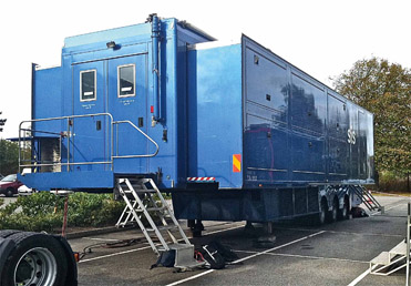 Figure 5.7 The upper photo shows the exterior of a very large remote production truck and the inside of a large truck is shown in the lower photo.
