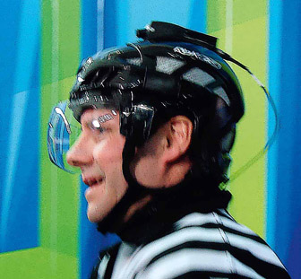 Figure 7.14 The first photo shows a POV “lipstick” camera being placed into the bull’s eye of an archery target to capture the incoming arrows. A POV camera attached to a referee’s helmet is shown in the second photo. The third photo shows an American football helmet, designed by SchuttVision, that incorporates a built-in POV camera. Used by ESPN and CBS, the images are recorded on an SD card or transmitted via a signal broadcast.