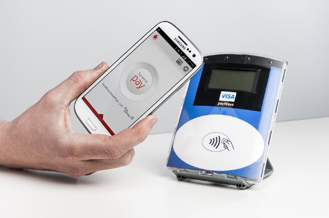 Tapping an NFC reader with the Vodafone SmartPass; in 2012, the Vodafone SmartPass pilot in Australia gave ANZ bank customers Galaxy SIII phones with an NFC wallet app preinstalled, to use at the 100,000 shops with contactless terminals in the country