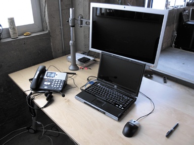 A standard remote lab setup: a two-line desk phone, laptop with wired Internet connection, a second monitor, and a phone headset. You may also need a phone tap and amplifier to record audio, depending on your recording setup.