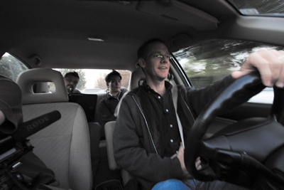 The moderator rides along in the back seat, observing and filming the driver. The footage is streamed live to the Web.