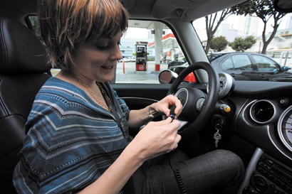 A driver multitasks while stopped in traffic.