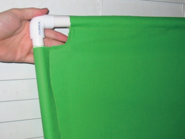 This poor man’s green screen cost $20, and is made with four yards of fabric from a fabric store, 24 feet of plastic pipe, and four “L” joints.