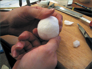 Sculpt a Styrofoam ball into a head shape.