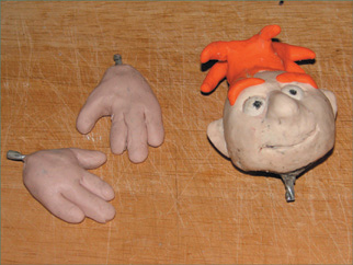 Head and hands are completely sculpted in clay.