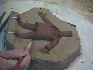 Building up a clay bed around the sculpt. (Copyright Zung Studio.)