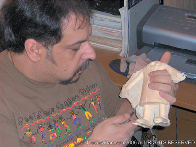 Paul Moldovanos snips away excess foam from his puppet. (Courtesy of the Clayman’s 3D Cartoon Communications.)