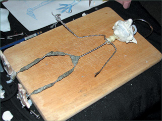 Epoxy putty and a doll armature neck are added to the armature.